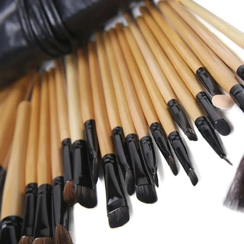 24 professional makeup brushes with wooden handles stored in a black PU gift bag.