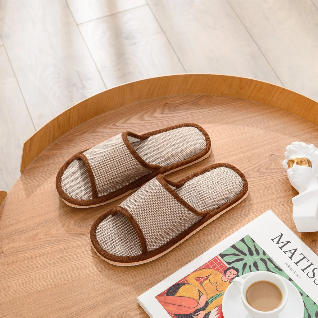 Women's open-toe linen slippers in a light brown colour showing the breathable fabric and thickened sole.