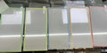 Fluorescent tempered glass screen protector for iPhone with glowing green edge on a phone