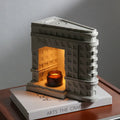 Wukang Building concrete wax lamp with halogen fixtures in white on a wooden table