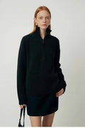 A woman's loose lapels bandage dress in wool, shown in black and grey, with long sleeves.