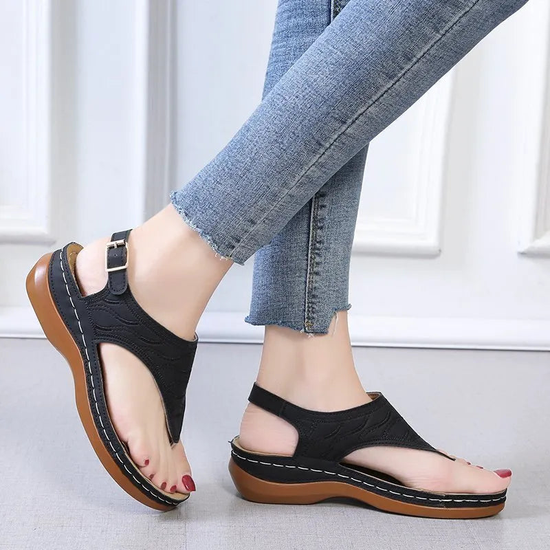 Women's black casual wedge heel sandals with an adjustable back strap buckle.