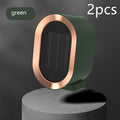 Compact black desktop electric fan heater with mechanical dial control on a wooden desk.