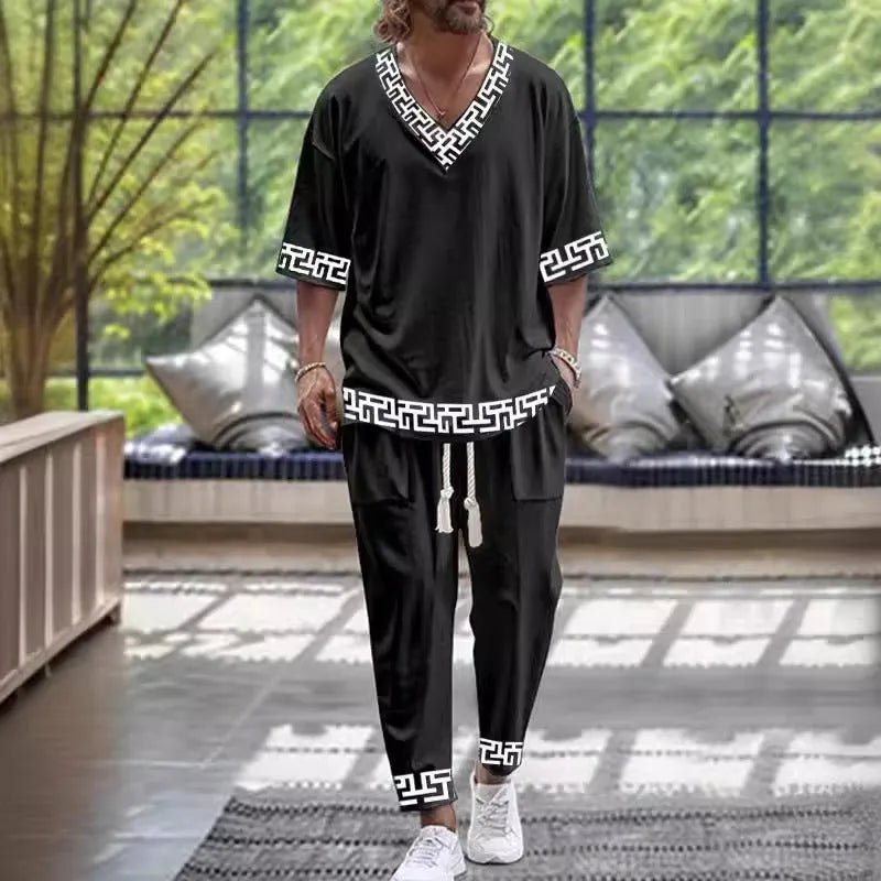 Lightweight polyester trousers suit with cropped sleeve V-neck jacket on a hanger.