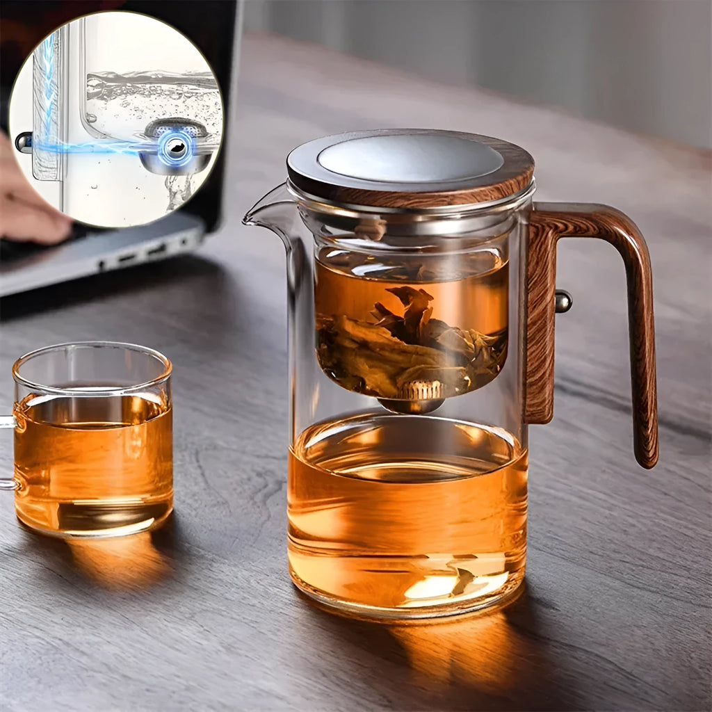 Glass teapot with wooden handle showing magnetic tea separation button and drip-free spout.