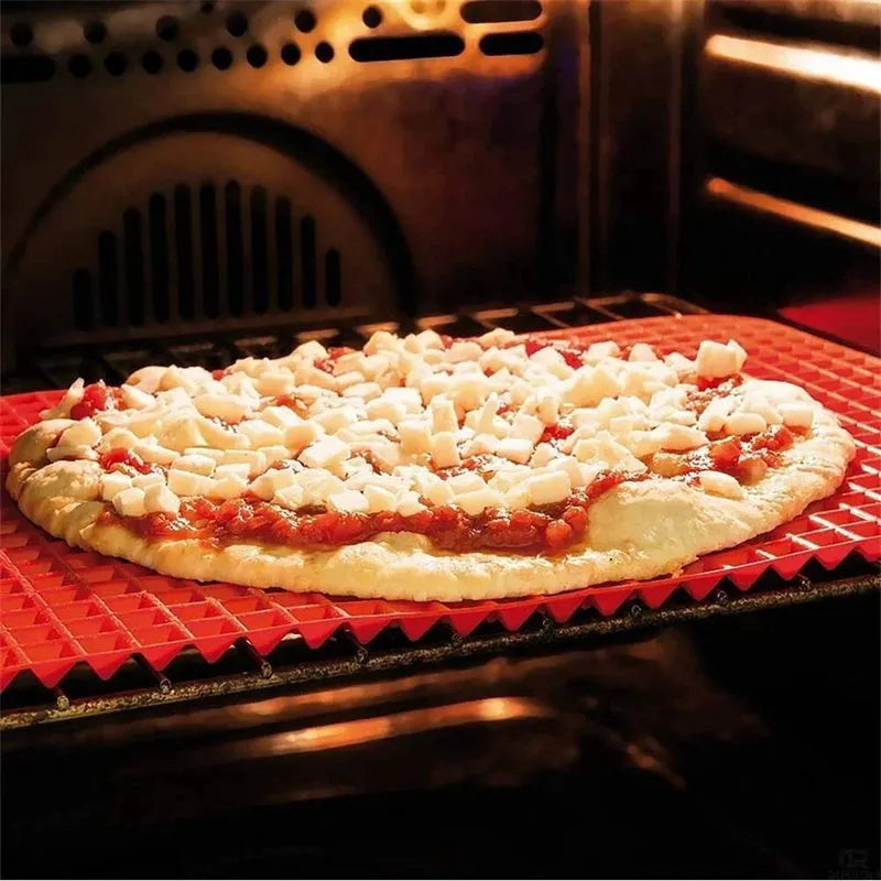 Red silicone pyramid grid cooking mat on a kitchen countertop.