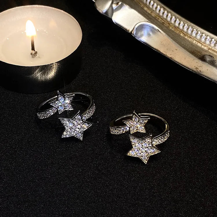 Gold cold style zircon star open-end ring and bracelet set on white background