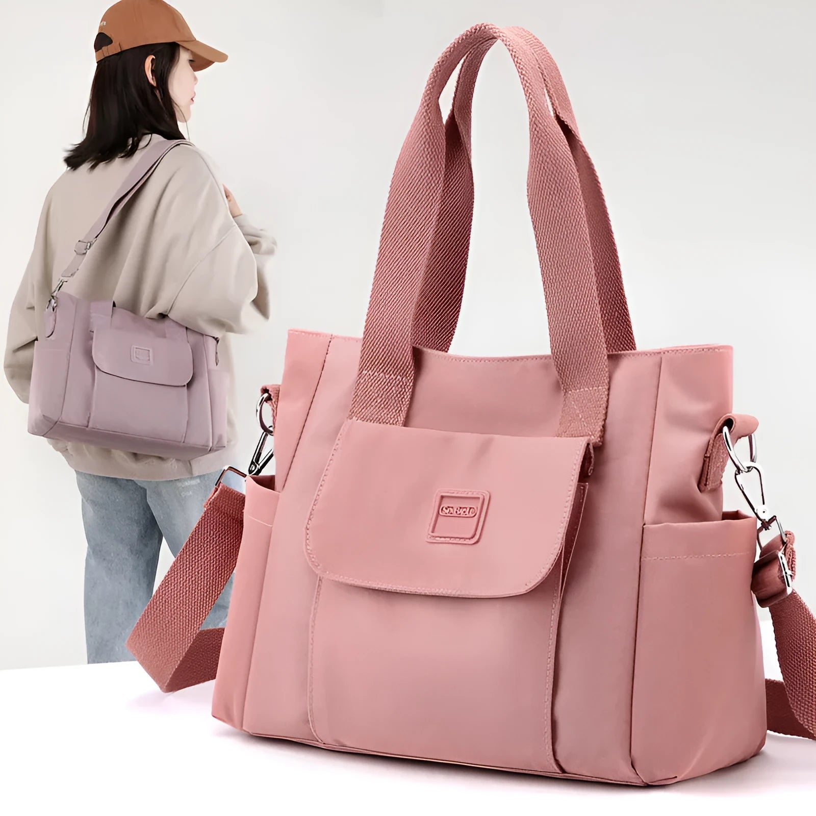 Nylon multi-interlayer shoulder bag in black with single strap and outer sandwich pocket, horizontal square shape