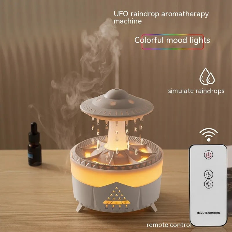 UFO cloud-shaped humidifier with LED lights and water droplet effects on dark surface