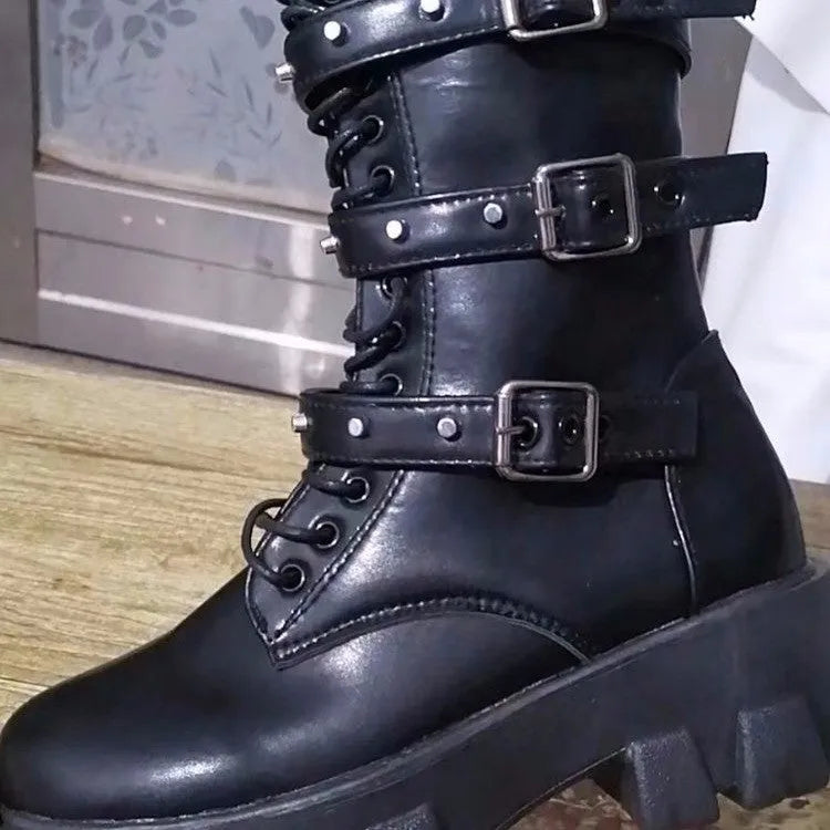 Black women's mid-calf knight boots with metal buckle detail and side zip on a white background