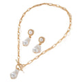Gold baroque pearl pendant necklace and matching ear stud jewellery set on white background