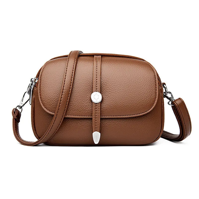 Women's soft PU crossbody shoulder bag with oval suitcase shape in black, khaki, or dark brown