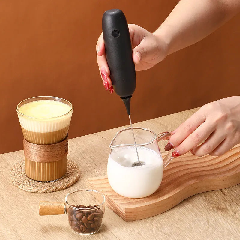 Black and white handheld electric milk frother and blender with modern design