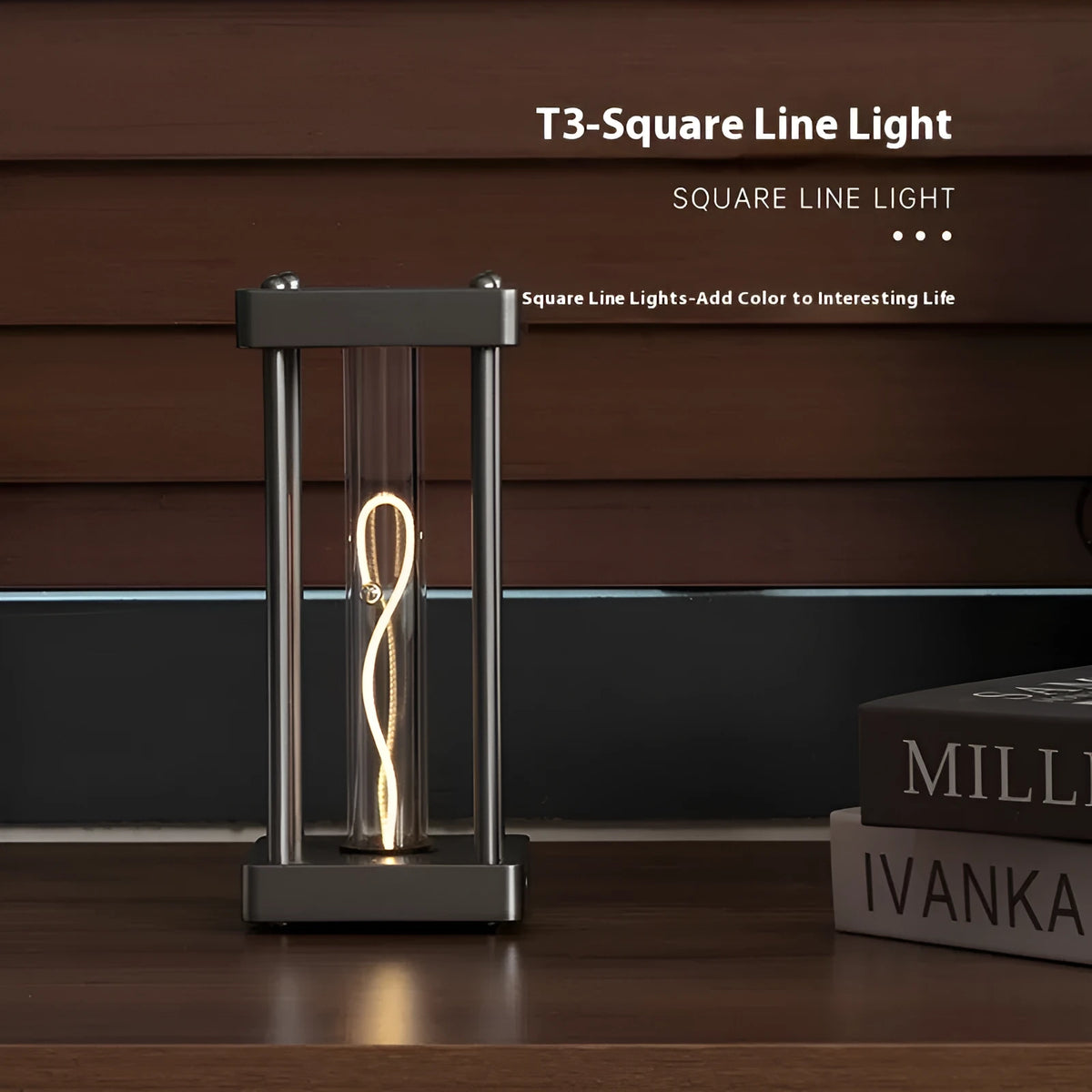Metallic gray acrylic square night lamp with curved wire on a desk