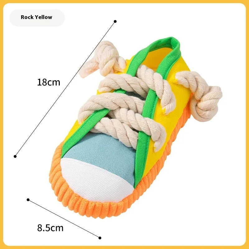 Slipper-shaped plastic dog chew toy with a squeaker, shown in yellow, black, and blue colour options.