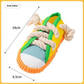 Slipper-shaped plastic dog chew toy with a squeaker, shown in yellow, black, and blue colour options.