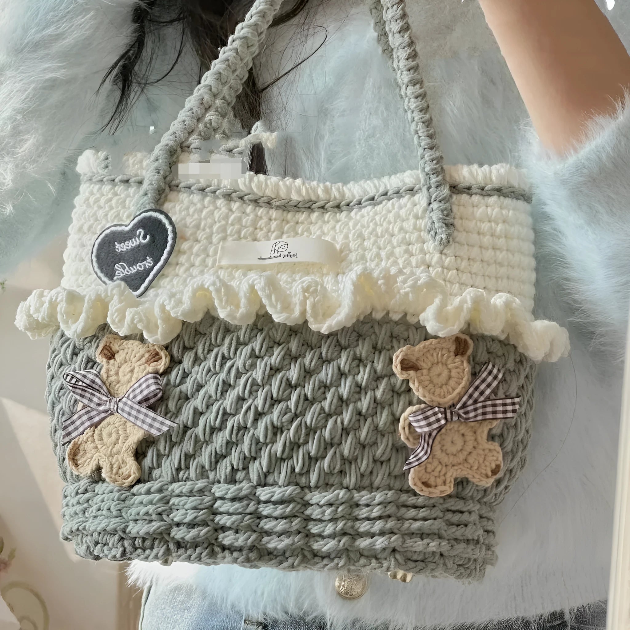 Wool crocheted bear shoulder bag with wooden handle on a crossbody strap