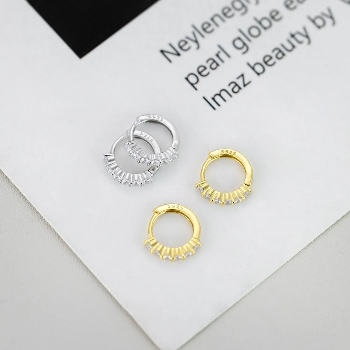 925 silver geometric stud earrings in white gold finish on white background