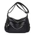 Large black women's crossbody shoulder bag with multiple internal compartments and zip closure