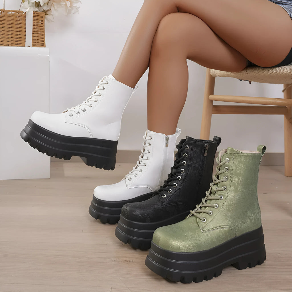 Women's black retro platform Martin boots with patchwork detail and side zipper.
