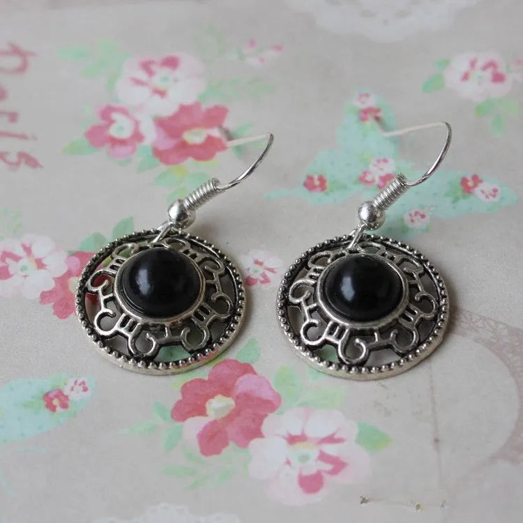 Handmade Tibetan silver geometric flower disk earrings with turquoise stones and ethnic Miao patterns.