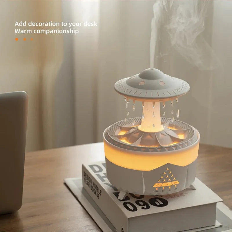 UFO cloud-shaped humidifier with LED lights and water droplet effects on dark surface