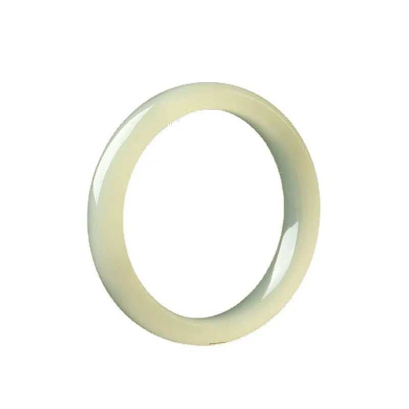 A close-up of a winding jade bracelet made from round bar beads on a wrist.