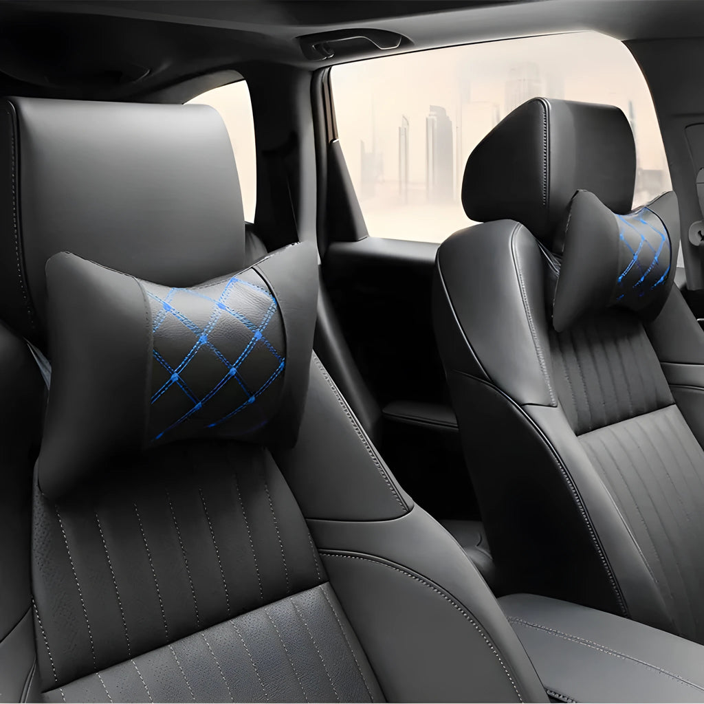 Black quilted leather car headrest pillow with contrast stitching, shown on a car seat.