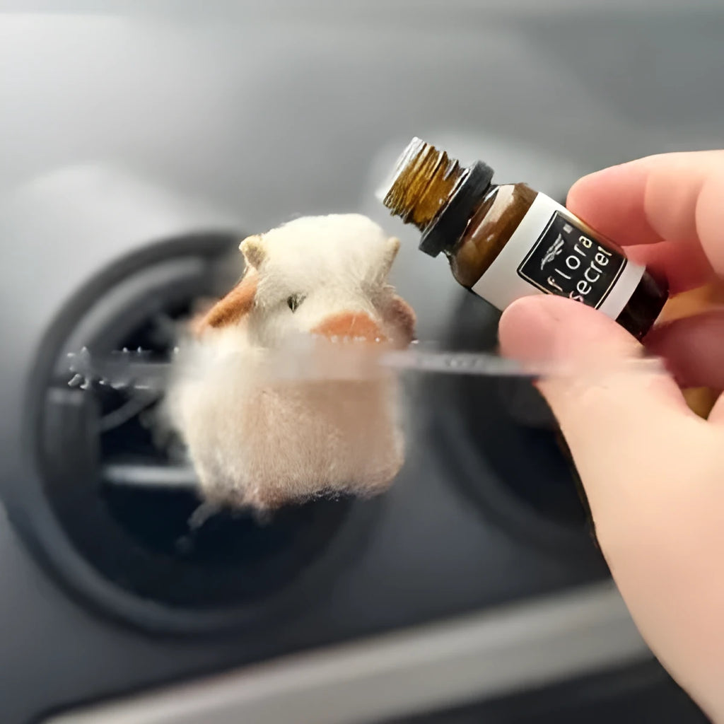 Scottish Highland Niutong air outlet clip in white plastic on a car dashboard vent