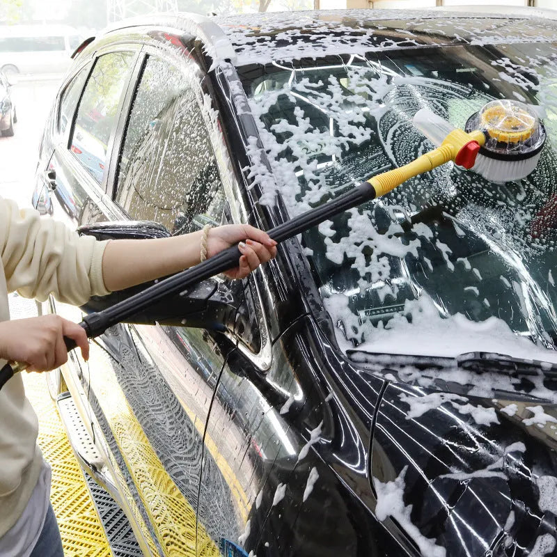 Yellow car wash mop cleaning tool with a long handle and chenille brush head.