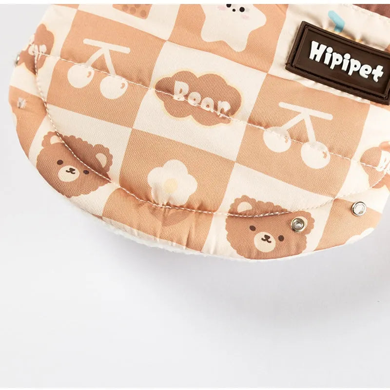 Quilted two-legged pet vest with leash ring in brown bear print or geometric red-green, sizes XS-XXL.