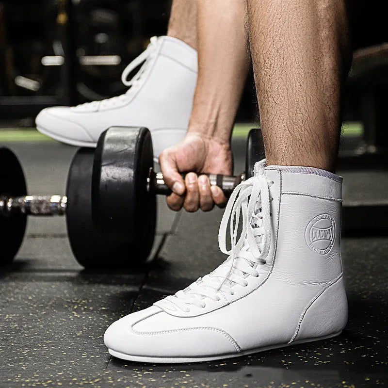 Professional black and gold mesh boxing shoes with a non-slip rubber sole for indoor training.