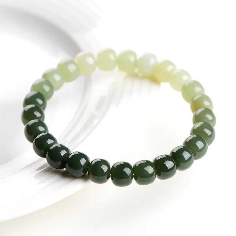 Natural Hetian jade bracelet with gradient clear water colour on a wrist.