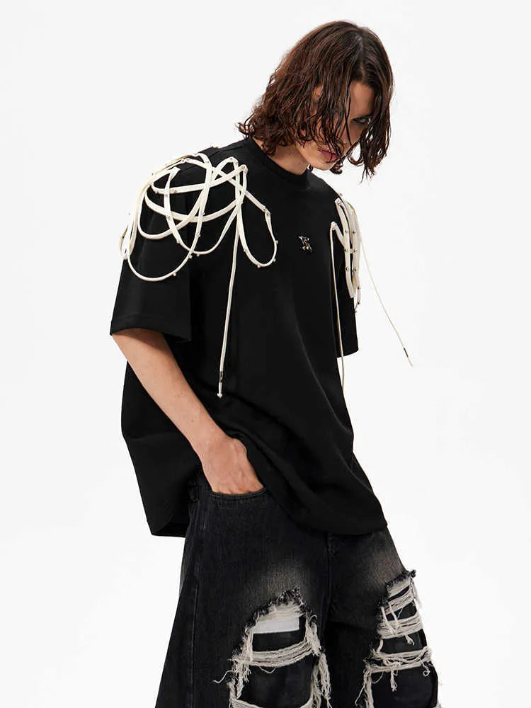 Black loose fit women's T-shirt with padded shoulders and decorative rivet ribbon detail.