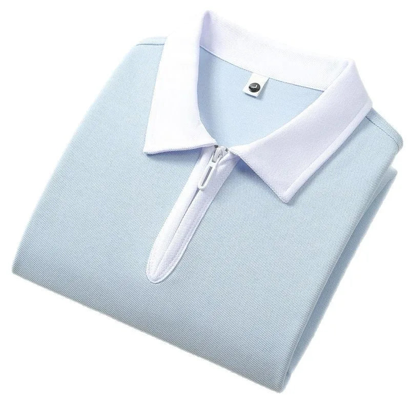 Man wearing a solid colour polo shirt with a zip-up lapel collar and short sleeves.