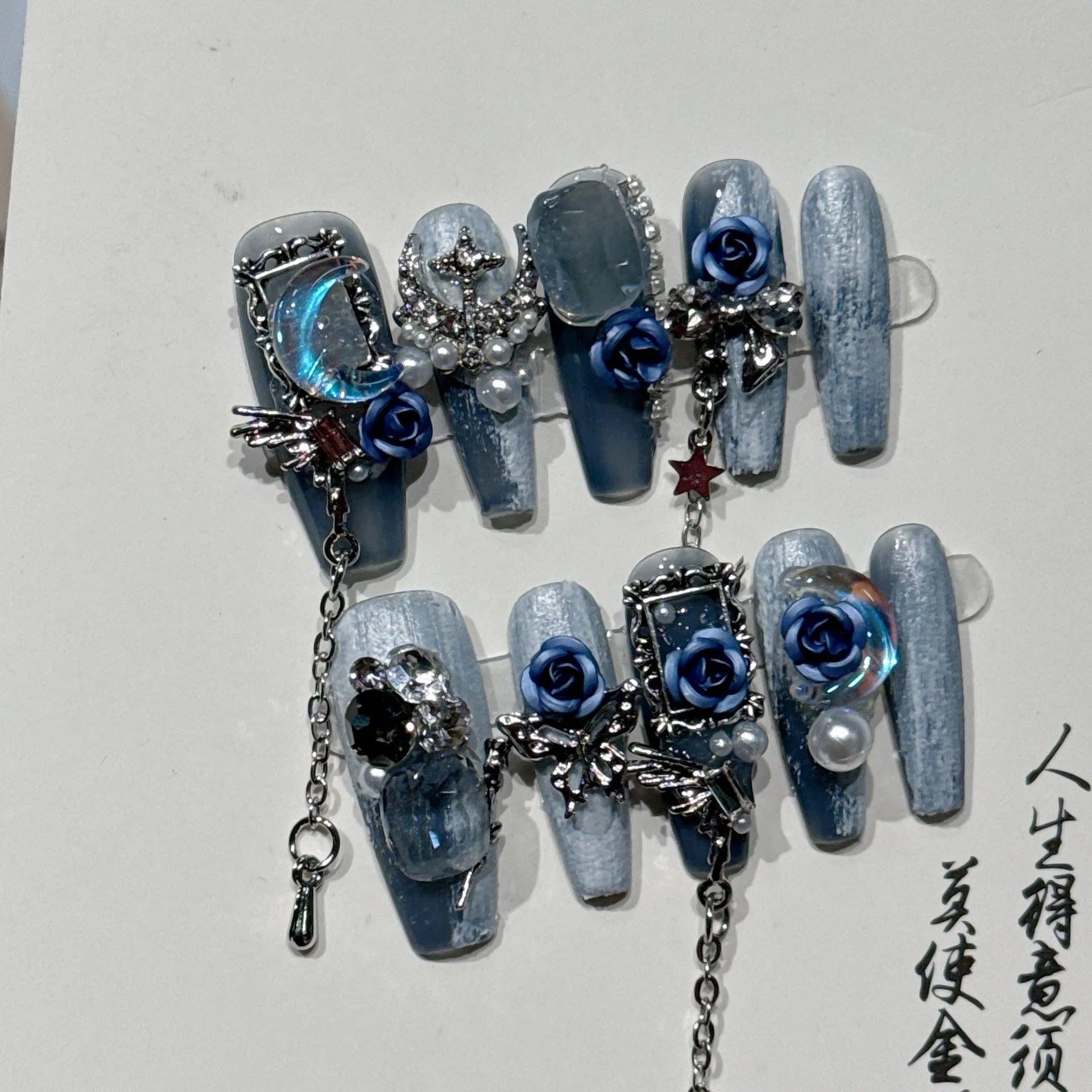 Ornate rose and tulip pattern nail wraps in deep blue night colour on a plastic armour suit.