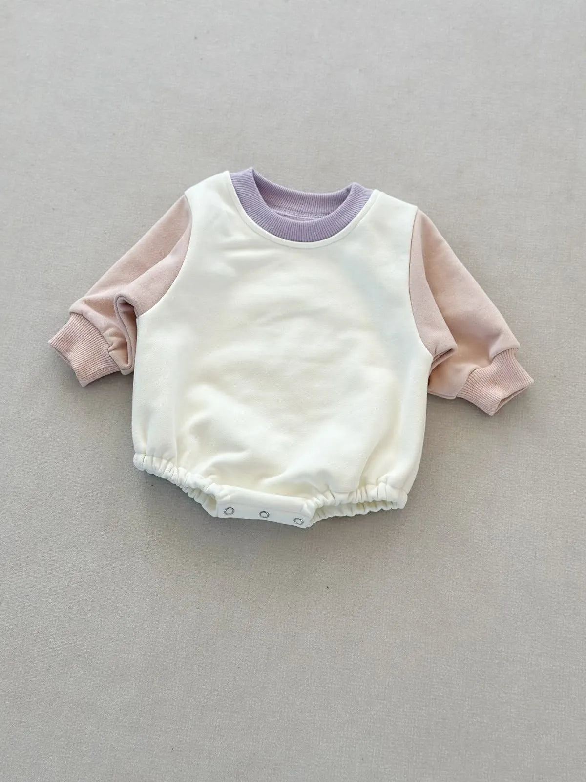 Baby romper in cotton triangle jumpsuit style with hidden hook closure, autumn weight, available in multiple colours