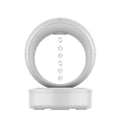 White round anti-gravity air humidifier with levitating water droplets on a desk