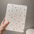 Transparent floral patterned iPad case folded into standing position showing magnetic closure and port cutouts