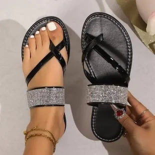 Women's black beach sandals with rhinestone toe straps and flat rubber sole