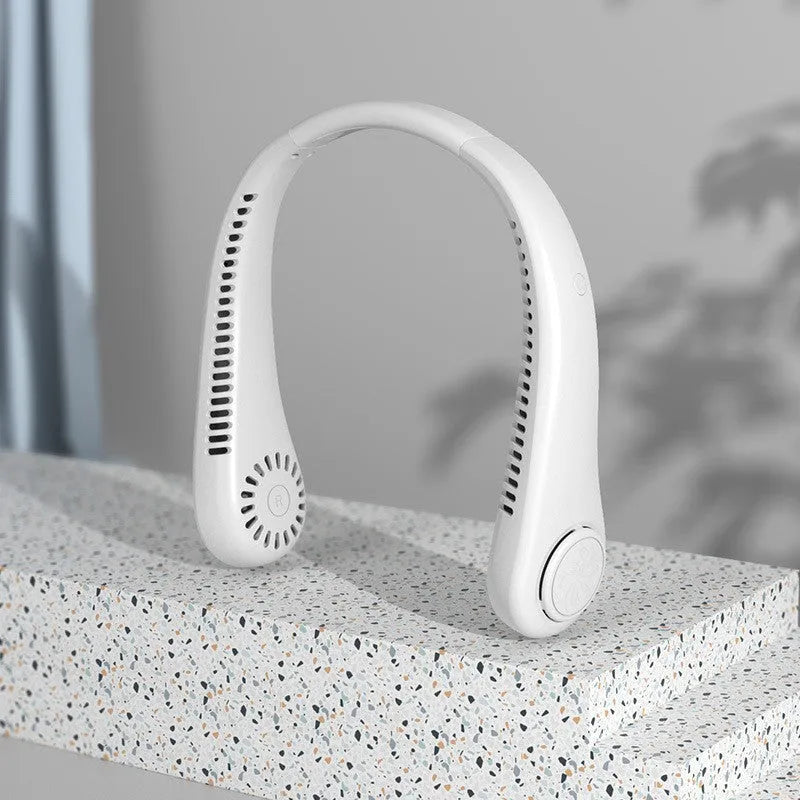 Blue bladeless neck fan hanging around a person's neck, showing the air outlet and USB charging port.