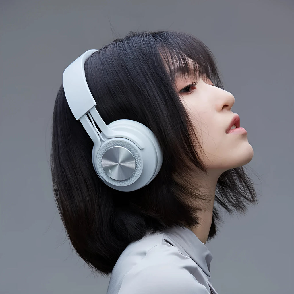 Red sports wireless Bluetooth headset on a grey background showing earcup and headband.