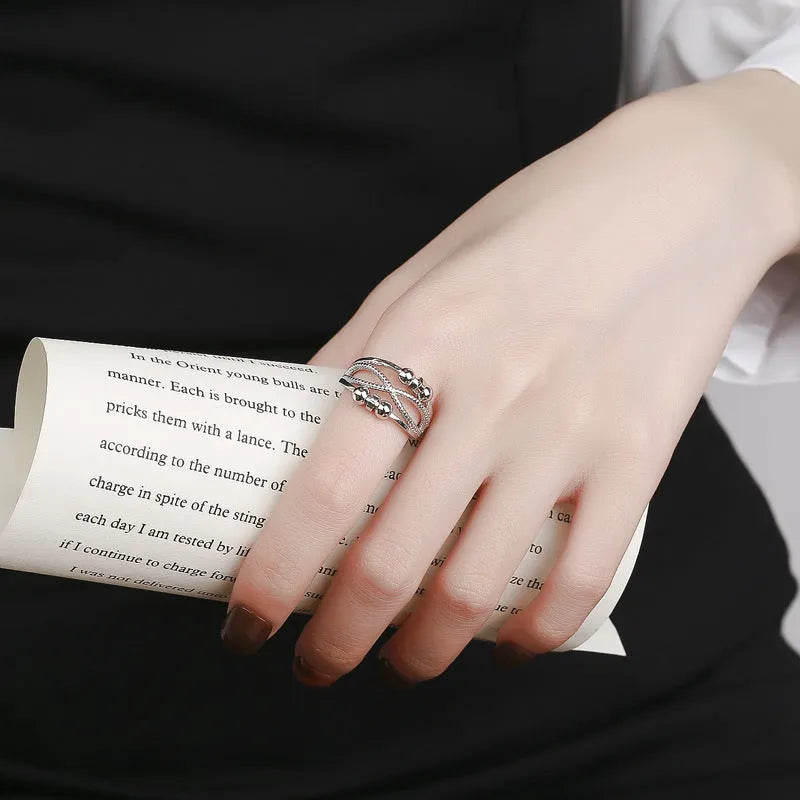 Rotatable copper ring with open design double-layered hollow line construction in platinum colour geometric shape