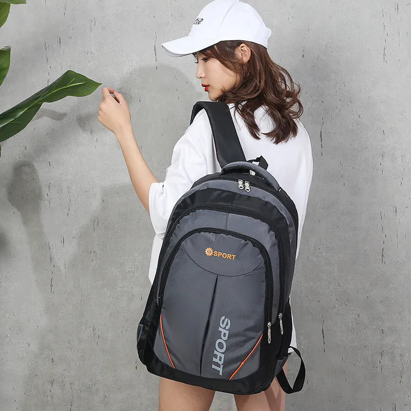 Large nylon laptop travel backpack in black with curved shoulder straps and letter detailing