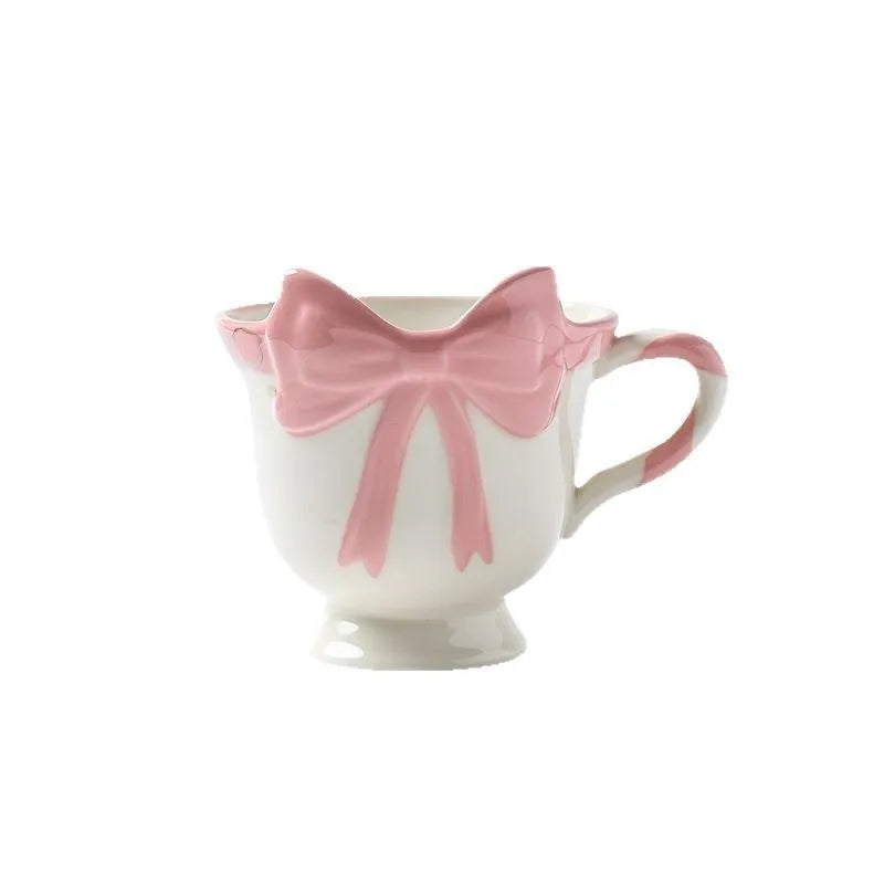 Ceramic mug with heart bow design in black pink and white powder colour options