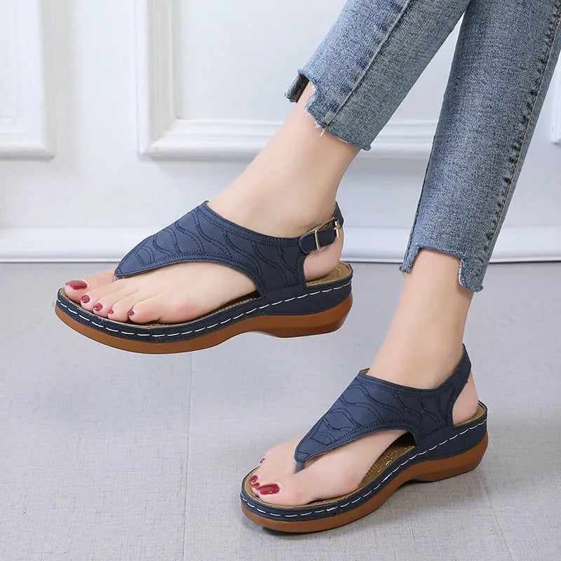 Women's black casual wedge heel sandals with an adjustable back strap buckle.