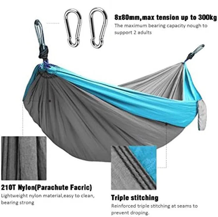 Sapphire blue parachute nylon hammock hung between trees, showing its full 270cm length and woven texture.