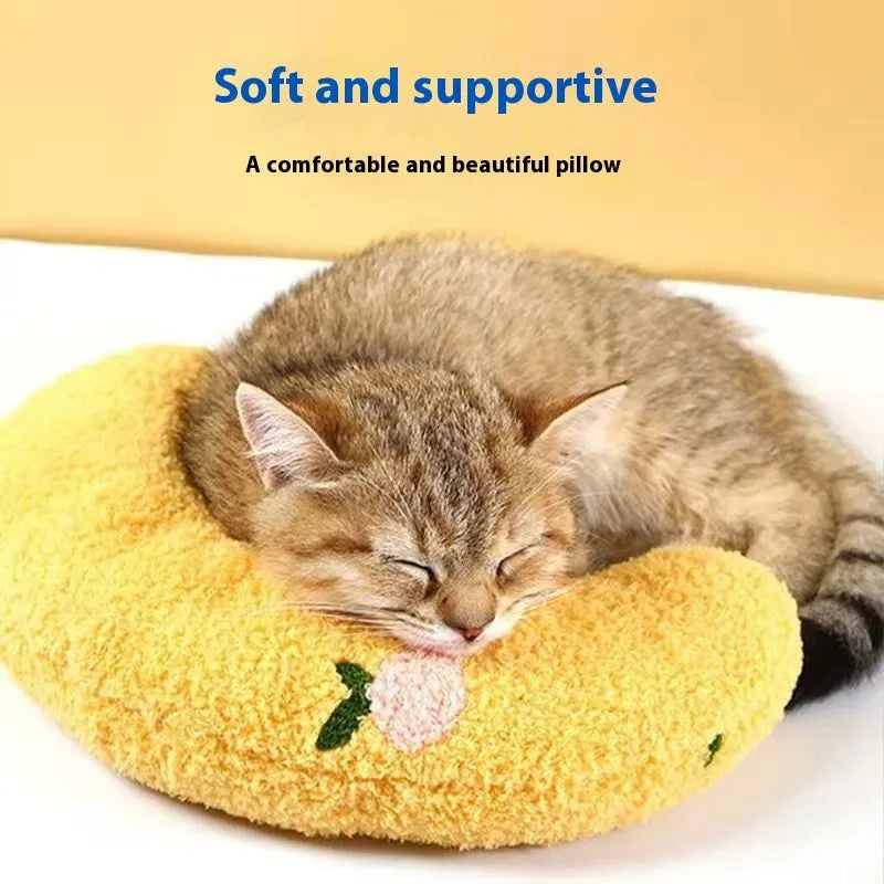 Blue and yellow question mark shaped cat bed with a built-in U-shaped neck support pillow on a wooden floor.