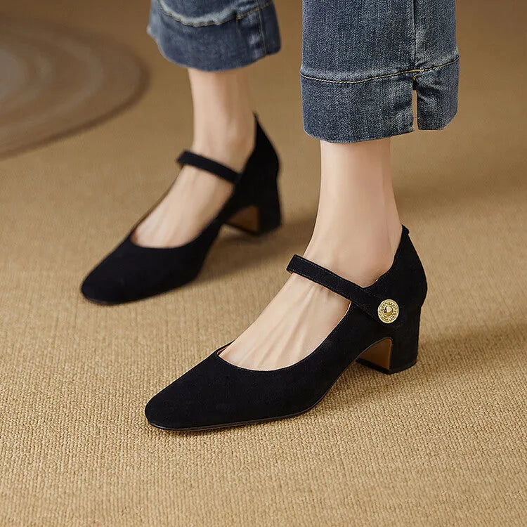 Women's black suede Mary Jane shoes with a chunky heel and square toe on a white background