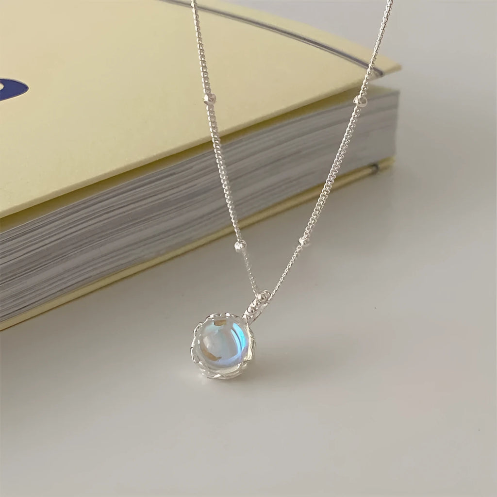 Women's 925 silver necklace with a round ornamental stone pendant on an adjustable curb chain.